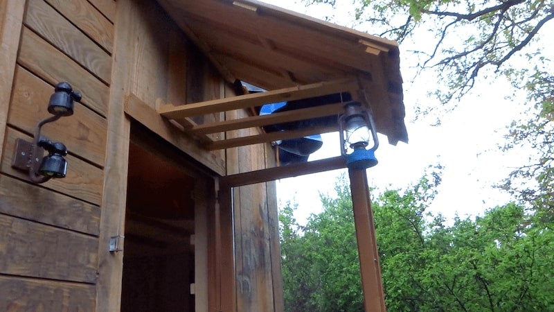 Photo de la marquise en bois qui protège la porte de notre tiny house.